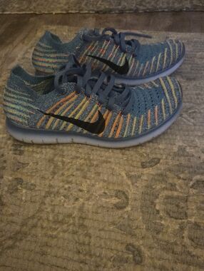 Nike Kids Blue Flyknit Sneakers with Orange and Yellow Stripes